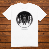 Wendigo engraved cryptid t-shirt — black and white crosshatch medallion design on white tee, flat lay