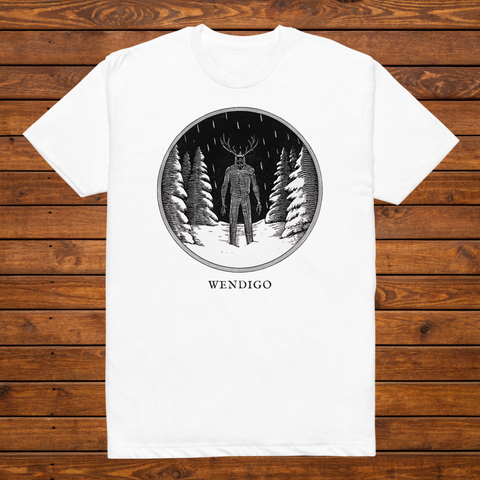 Wendigo engraved cryptid t-shirt — black and white crosshatch medallion design on white tee, flat lay