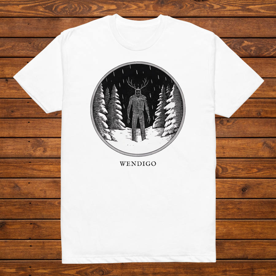 Wendigo engraved cryptid t-shirt — black and white crosshatch medallion design on white tee, flat lay