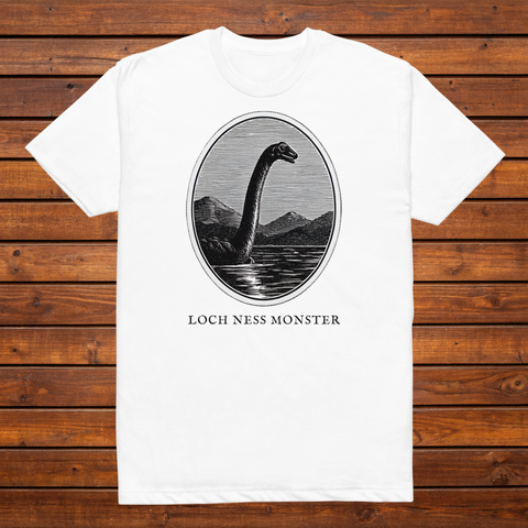 Loch Ness Monster engraved cryptid t-shirt — black and white crosshatch medallion design on white tee, flat lay