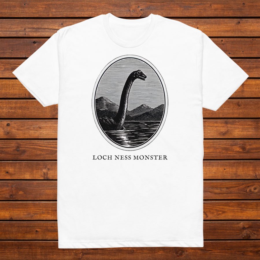 Loch Ness Monster engraved cryptid t-shirt — black and white crosshatch medallion design on white tee, flat lay