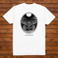 Mothman engraved cryptid t-shirt — black and white crosshatch medallion design on white tee, flat lay