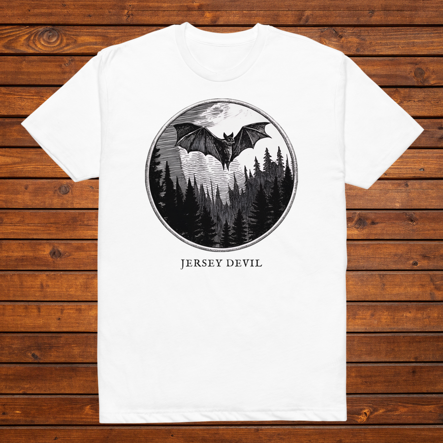 Jersey Devil engraved cryptid t-shirt — black and white crosshatch medallion design on white tee, flat lay
