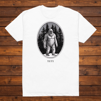 Yeti engraved cryptid t-shirt — black and white crosshatch medallion design on white tee, flat lay