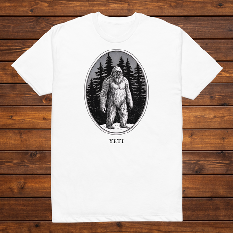 Yeti engraved cryptid t-shirt — black and white crosshatch medallion design on white tee, flat lay