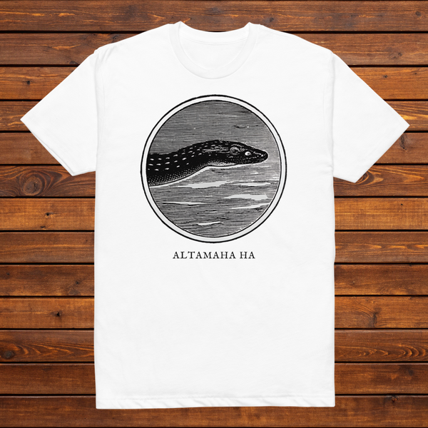Altamaha Ha engraved cryptid t-shirt — black and white crosshatch medallion design on white tee, flat lay