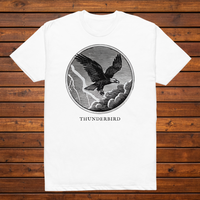 Thunderbird engraved cryptid t-shirt — black and white crosshatch medallion design on white tee, flat lay