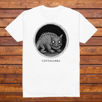 Chupacabra engraved cryptid t-shirt — black and white crosshatch medallion design on white tee, flat lay