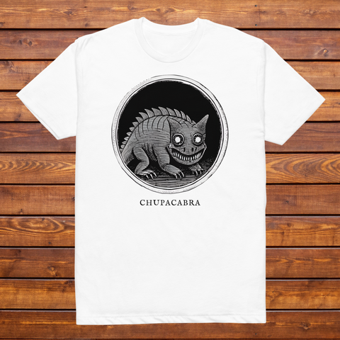 Chupacabra engraved cryptid t-shirt — black and white crosshatch medallion design on white tee, flat lay