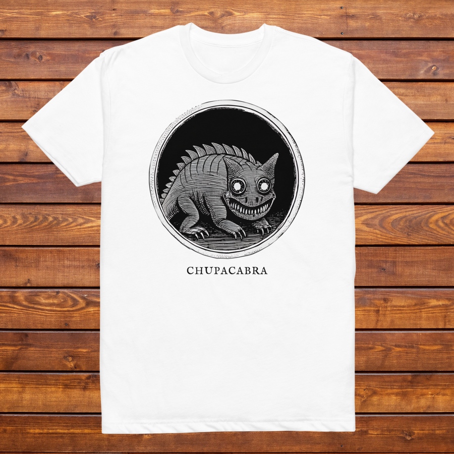 Chupacabra engraved cryptid t-shirt — black and white crosshatch medallion design on white tee, flat lay