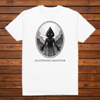 Flatwoods Monster engraved cryptid t-shirt — black and white crosshatch medallion design on white tee, flat lay